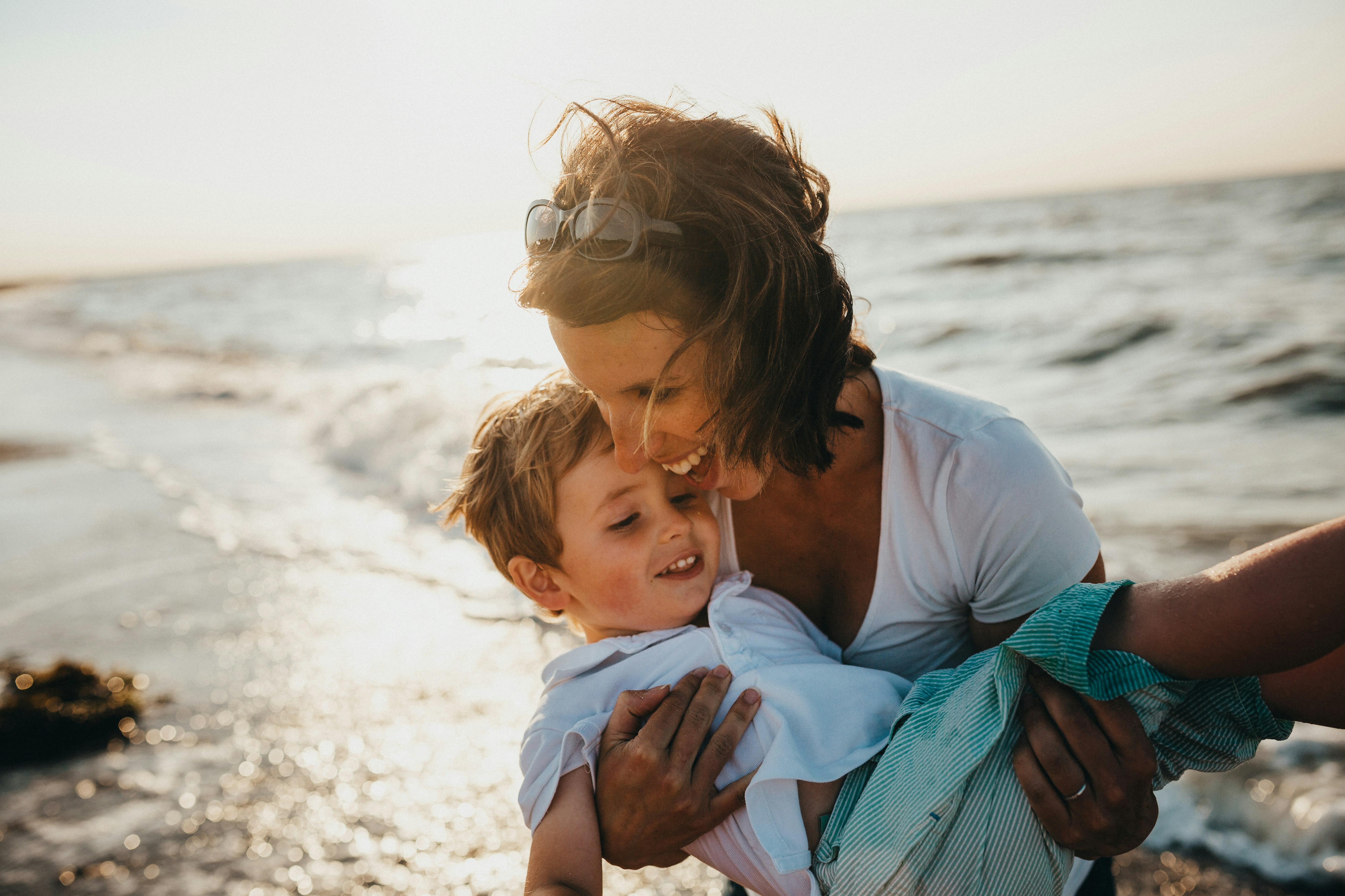 Happy mother and child at the beach - representing family protection and peace of mind with health insurance coverage